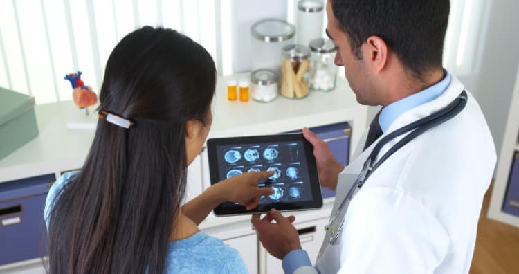 Doctor And Nurse Examining Patients Brain X Ray Scan