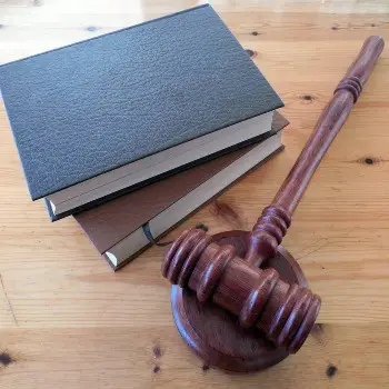 Personal Injury Law Books & Gavel On Wooden Table